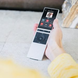 Woman holding a Control4 Halo remote in her hand